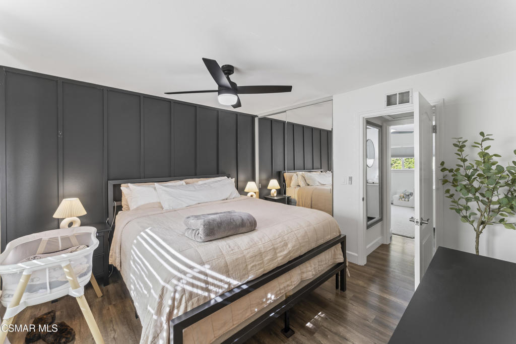 3585 Woodhaven Street Simi Valley, CA 93063 - Photo 17 of 33 a bedroom with a bed and a chandelier