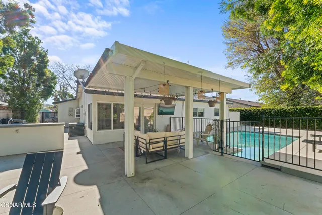 a view of a house with a wooden deck and a backyard
