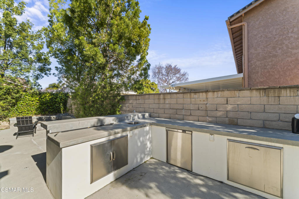 3585 Woodhaven Street Simi Valley, CA 93063 - Photo 27 of 33 a view of a kitchen with a sink and dishwasher