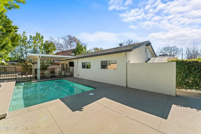 a aerial view of a house with a yard and potted plants