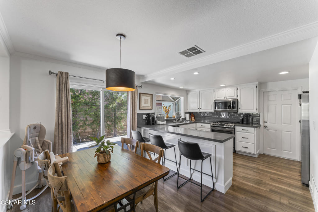 3585 Woodhaven Street Simi Valley, CA 93063 - Photo 4 of 33 a view of a dining room with furniture window and wooden floor