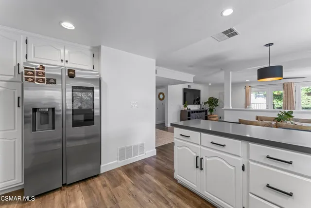 a kitchen with stainless steel appliances a refrigerator sink and cabinets