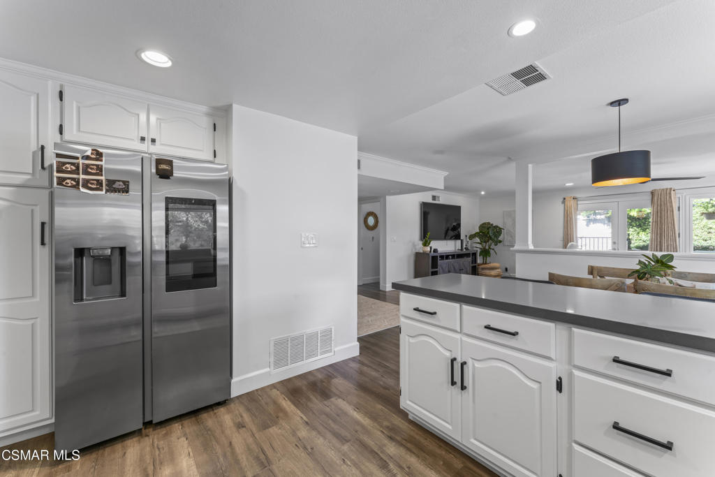 3585 Woodhaven Street Simi Valley, CA 93063 - Photo 8 of 33 a kitchen with stainless steel appliances a refrigerator sink and cabinets