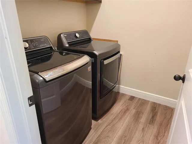 a close view of a sink and wooden floor