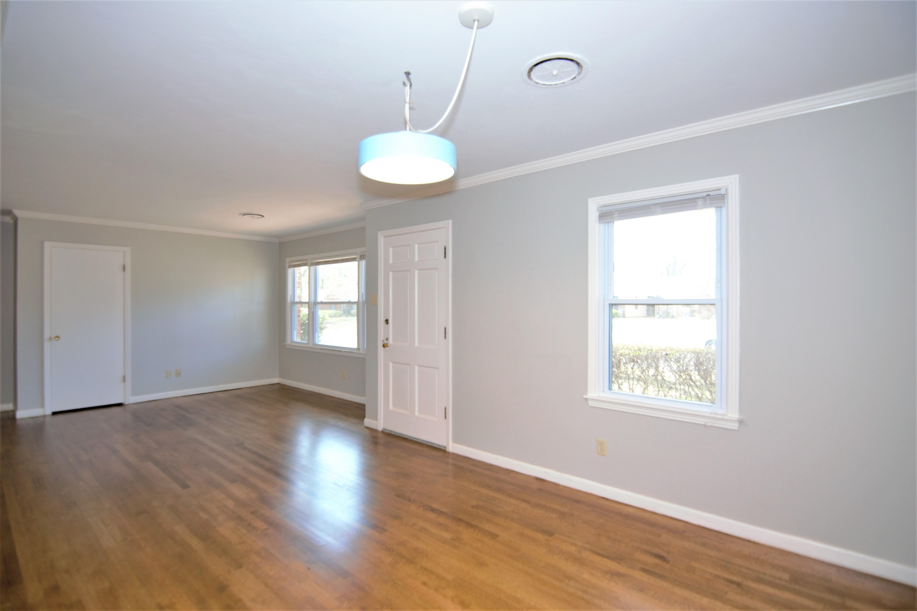1596 Rabb Road Memphis, TN 38119 - Photo 5 of 20 a view of an empty room with wooden floor and a window
