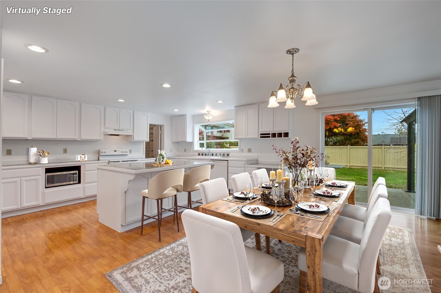 12649 Southeast 169th Place Renton, WA 98058 - Photo 3 of 38 a view of a dining room with furniture wooden floor and chandelier