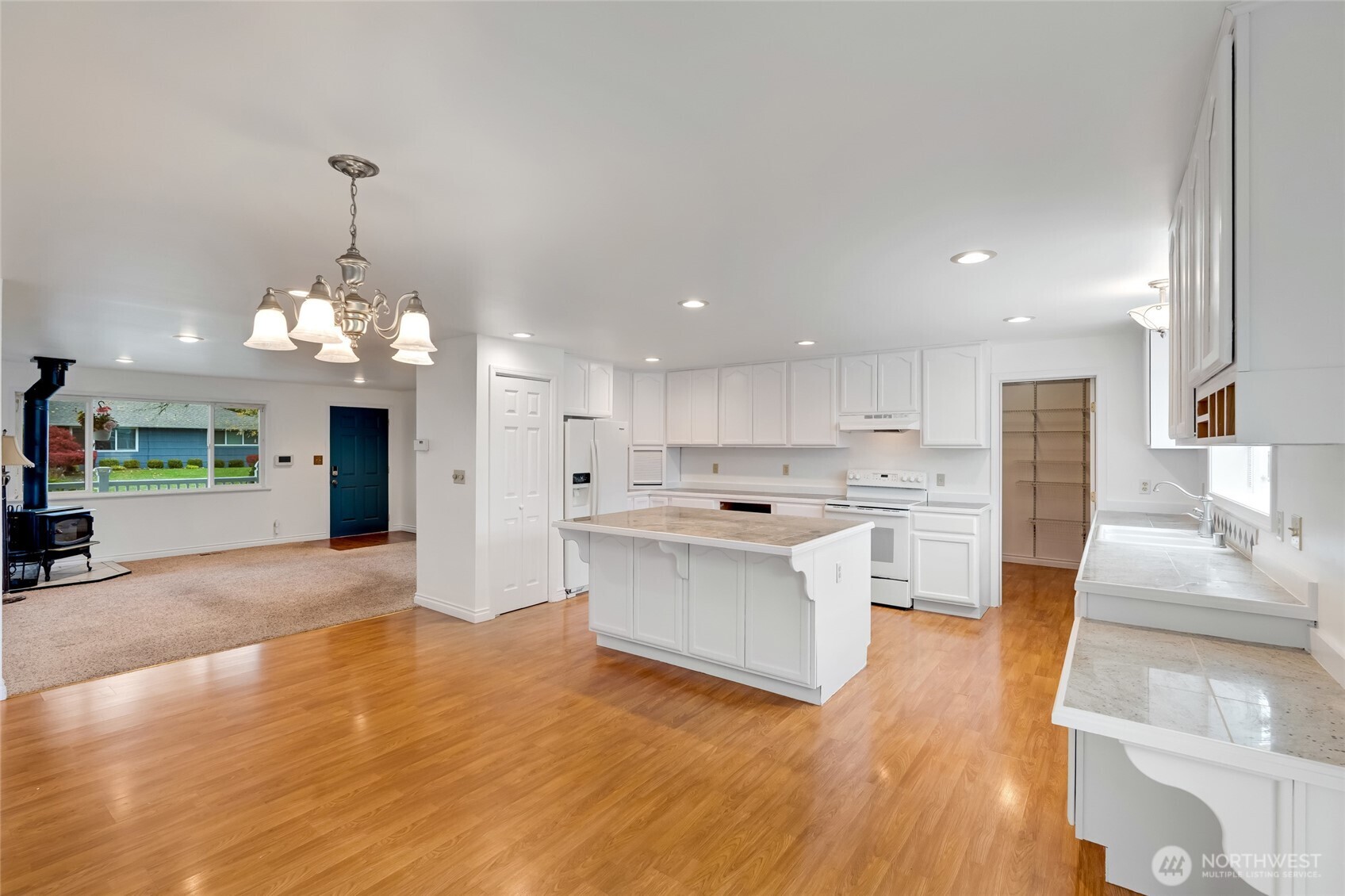 12649 Southeast 169th Place Renton, WA 98058 - Photo 4 of 38 a view of a kitchen with a sink wooden floor and a kitchen view