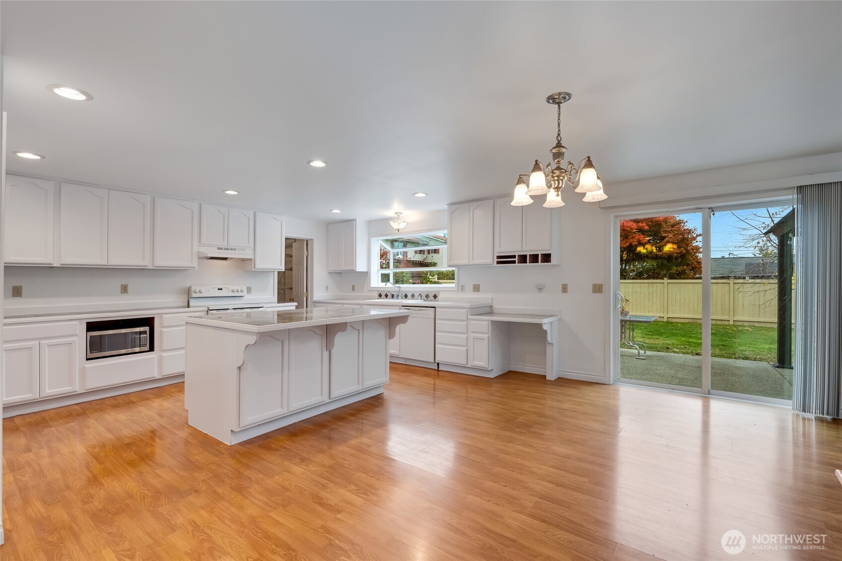12649 Southeast 169th Place Renton, WA 98058 - Photo 7 of 38 a large white kitchen with cabinets a sink and a stove
