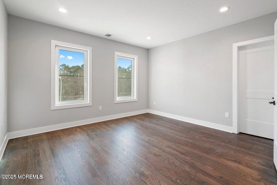 2 Haystack Court Howell, NJ 07731 - Photo 22 of 78 a view of an empty room with wooden floor and a window
