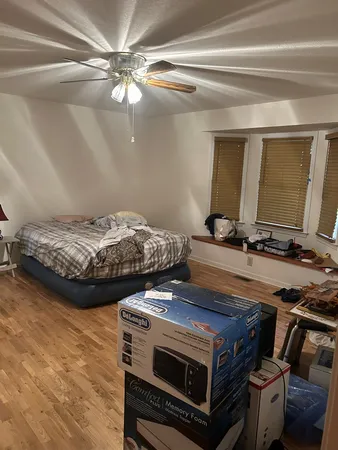 a bed sitting in a room next to a window