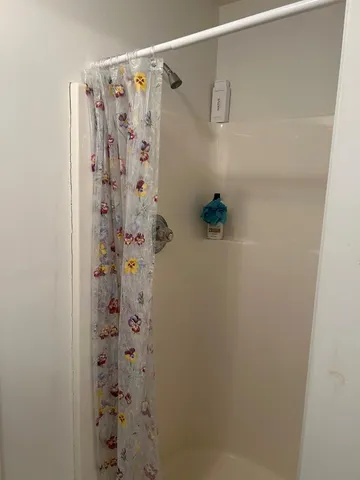 a bathroom with a shower curtain and a curtain
