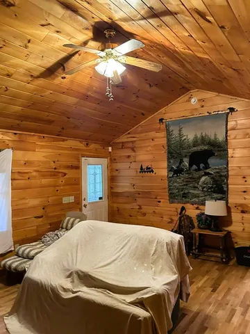 a bed sitting in a bedroom next to a window