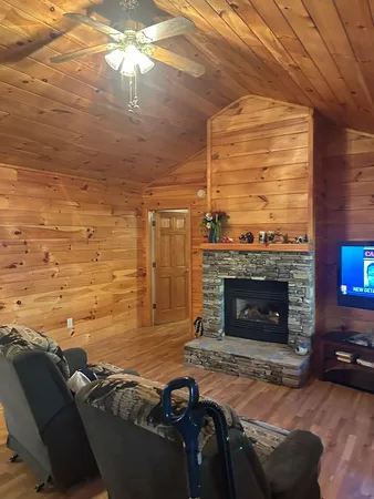a living room with furniture a fireplace and a flat screen tv