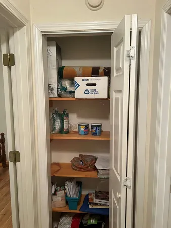 a room with a wooden floor and shelf