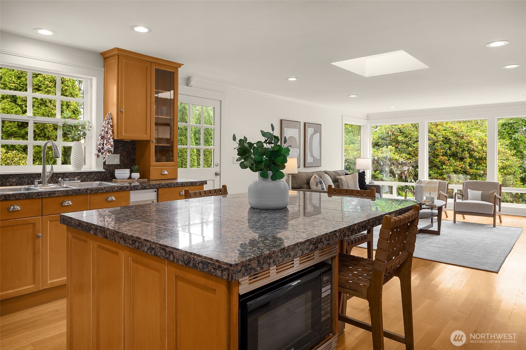3204 Evergreen Point Road Medina, WA 98039 - Photo 13 of 39 a kitchen with granite countertop a stove a sink a dining table and chairs
