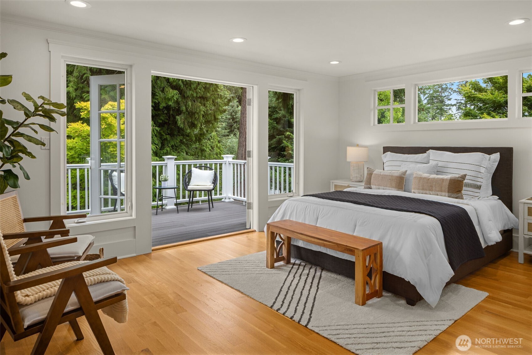 3204 Evergreen Point Road Medina, WA 98039 - Photo 20 of 39 a bedroom with a bed a large window and wooden floor