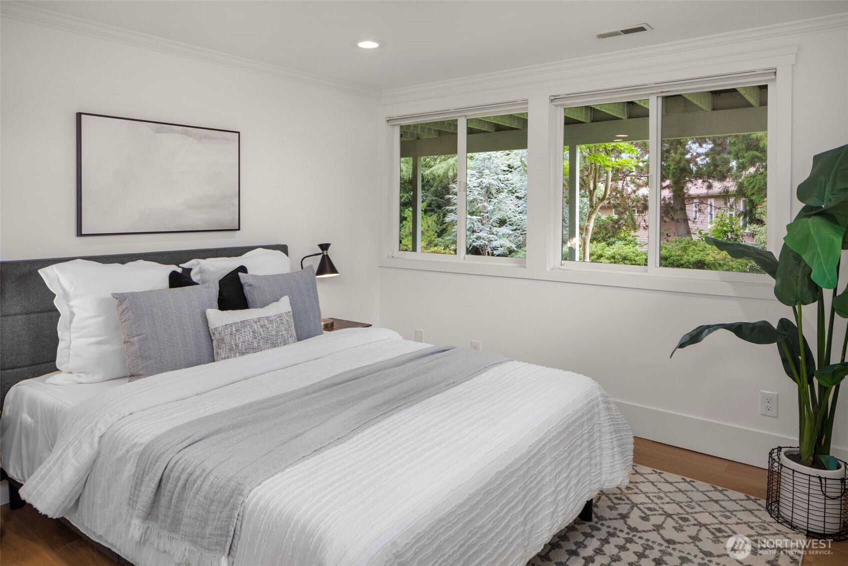 3204 Evergreen Point Road Medina, WA 98039 - Photo 26 of 39 a bedroom with bed and large window with potted plant