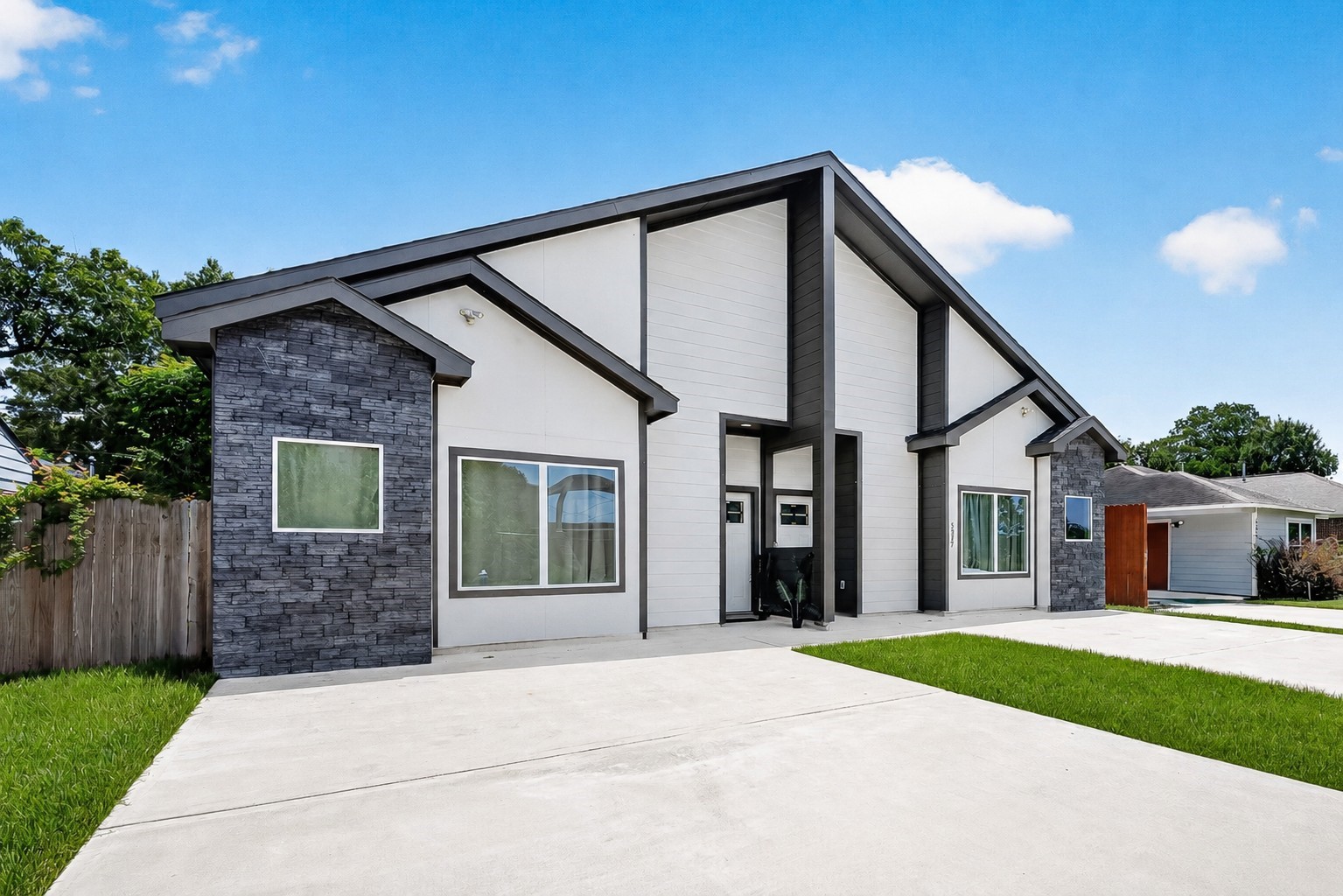 5027 Dickens Road, Unit B Houston, TX 77021 - Photo 13 of 24 Thoughtfully designed front elevation featuring a blend of stone and siding, soaring rooflines, oversized windows, and private individual entrances.