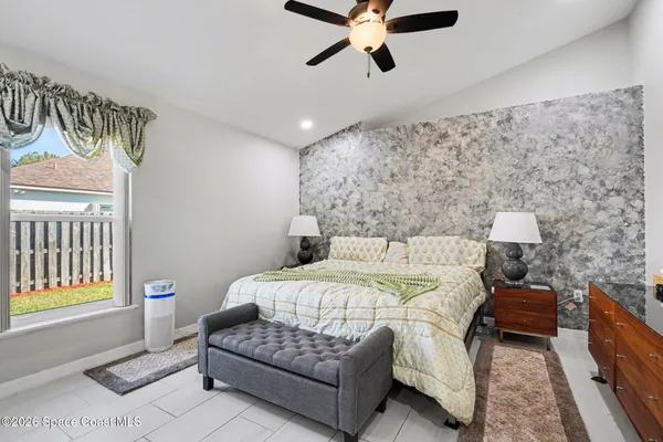 a bedroom with a bed couch and a window