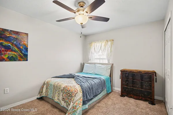 a bedroom with a bed dresser and a window