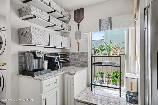 a kitchen with stainless steel appliances granite countertop a stove and a refrigerator