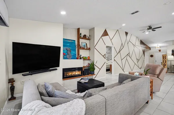 a living room with furniture and a flat screen tv