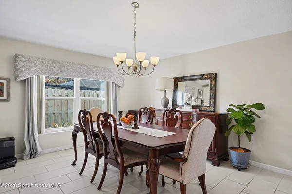 a view of a dining room with furniture and chandelier