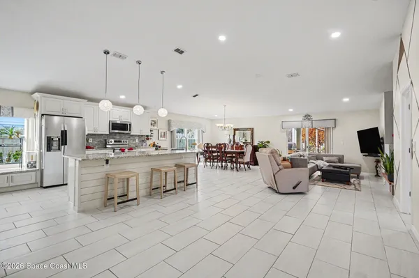 a living room with furniture a dining table and chairs