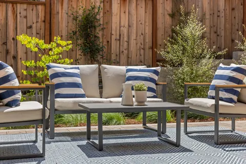 a building outdoor space with patio furniture and potted plants
