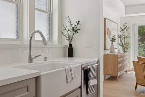 a kitchen with white cabinets and a sink