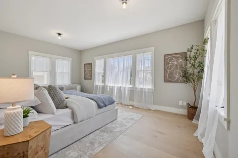 a bedroom with a bed and a potted plant