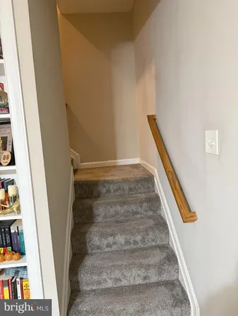 a view of staircase with white walls and a window