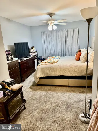 a bed room with a bed and a chair