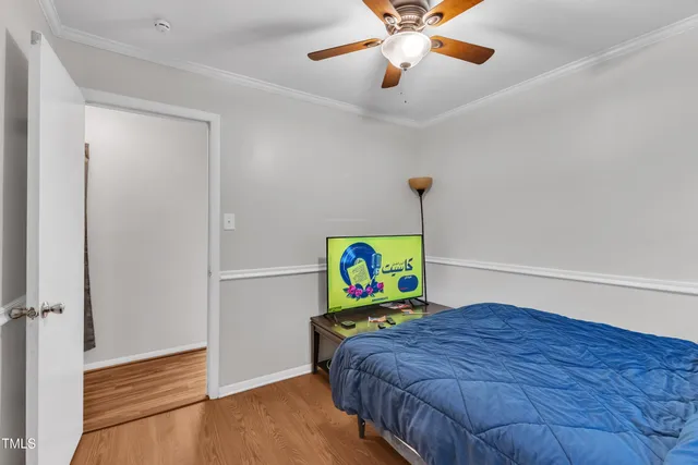 a bedroom that has a bed and a chandelier