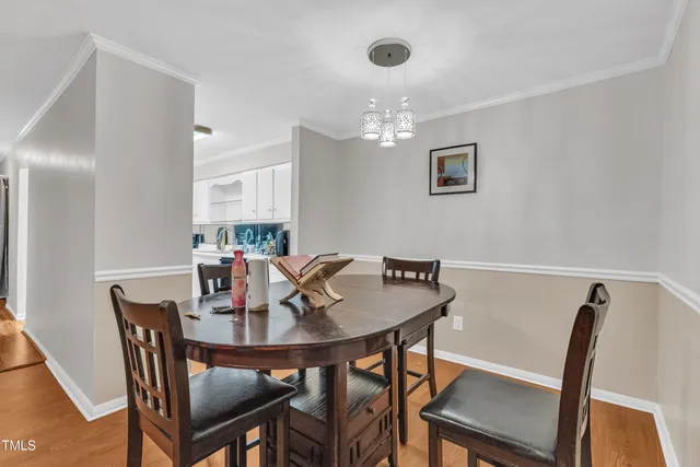 a view of a dining room with furniture and chandelier