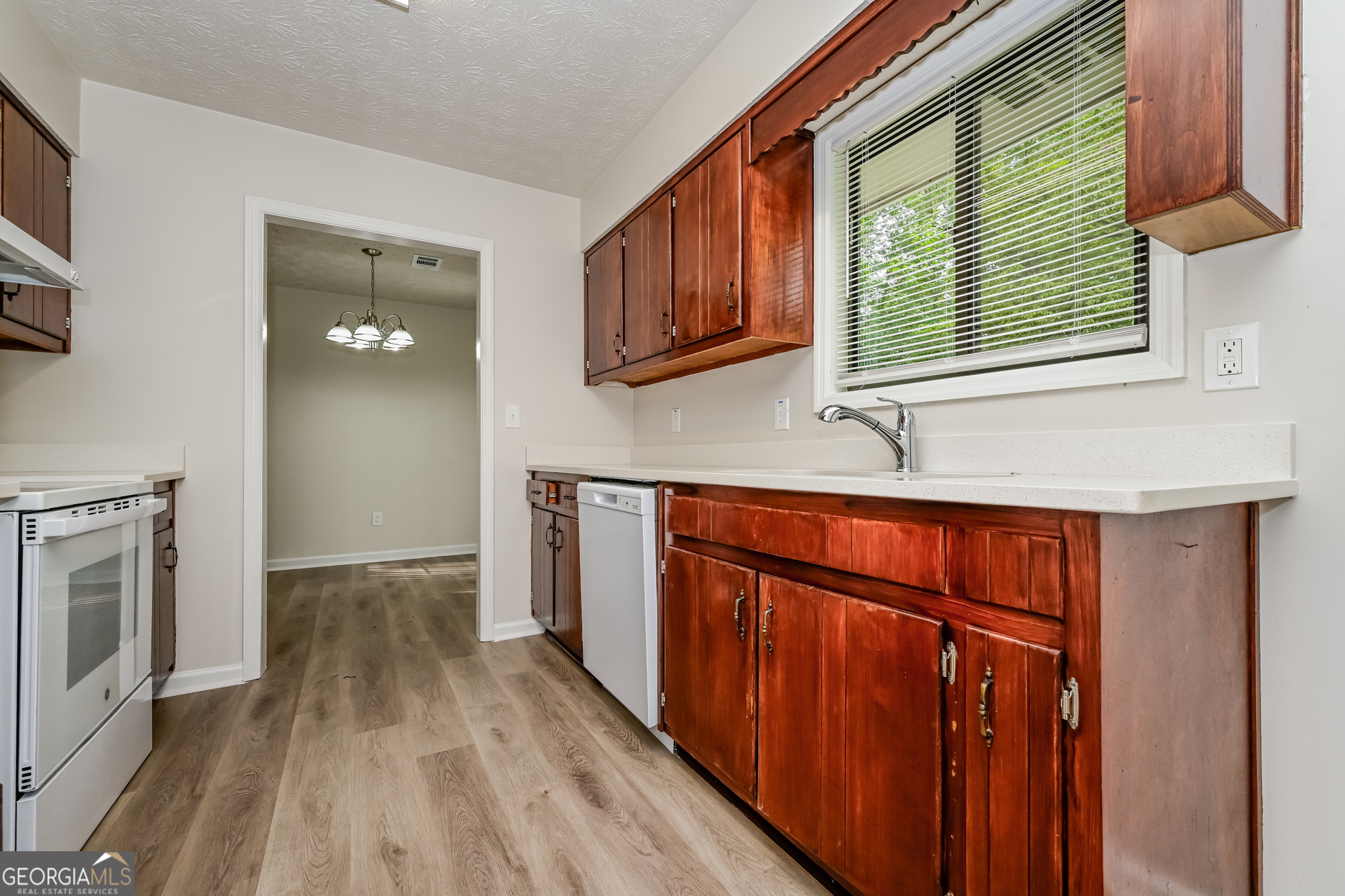 2140 Teri Lane Southeast Conyers, GA 30013 - Photo 6 of 16 a kitchen with stainless steel appliances granite countertop a refrigerator a sink dishwasher and wooden cabinets