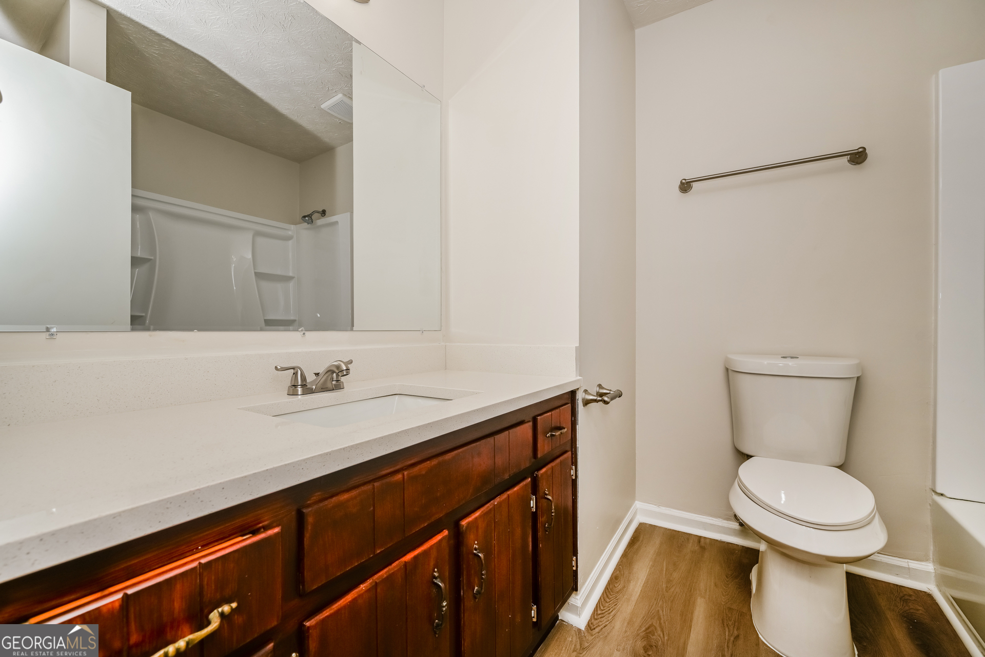 2140 Teri Lane Southeast Conyers, GA 30013 - Photo 9 of 16 a bathroom with a toilet a sink and a mirror