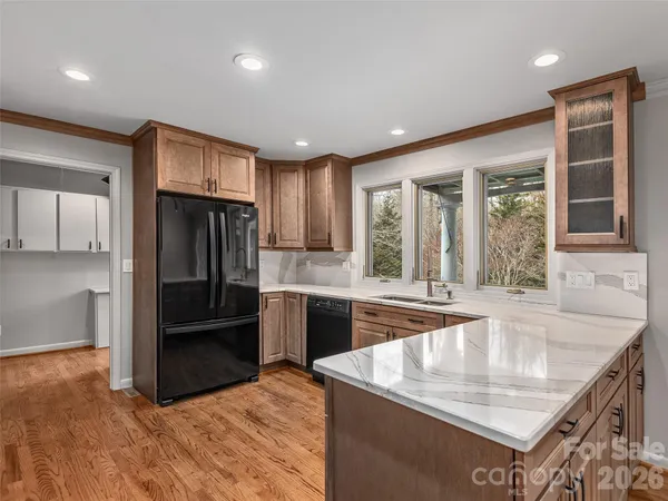a kitchen with granite countertop a refrigerator and a sink
