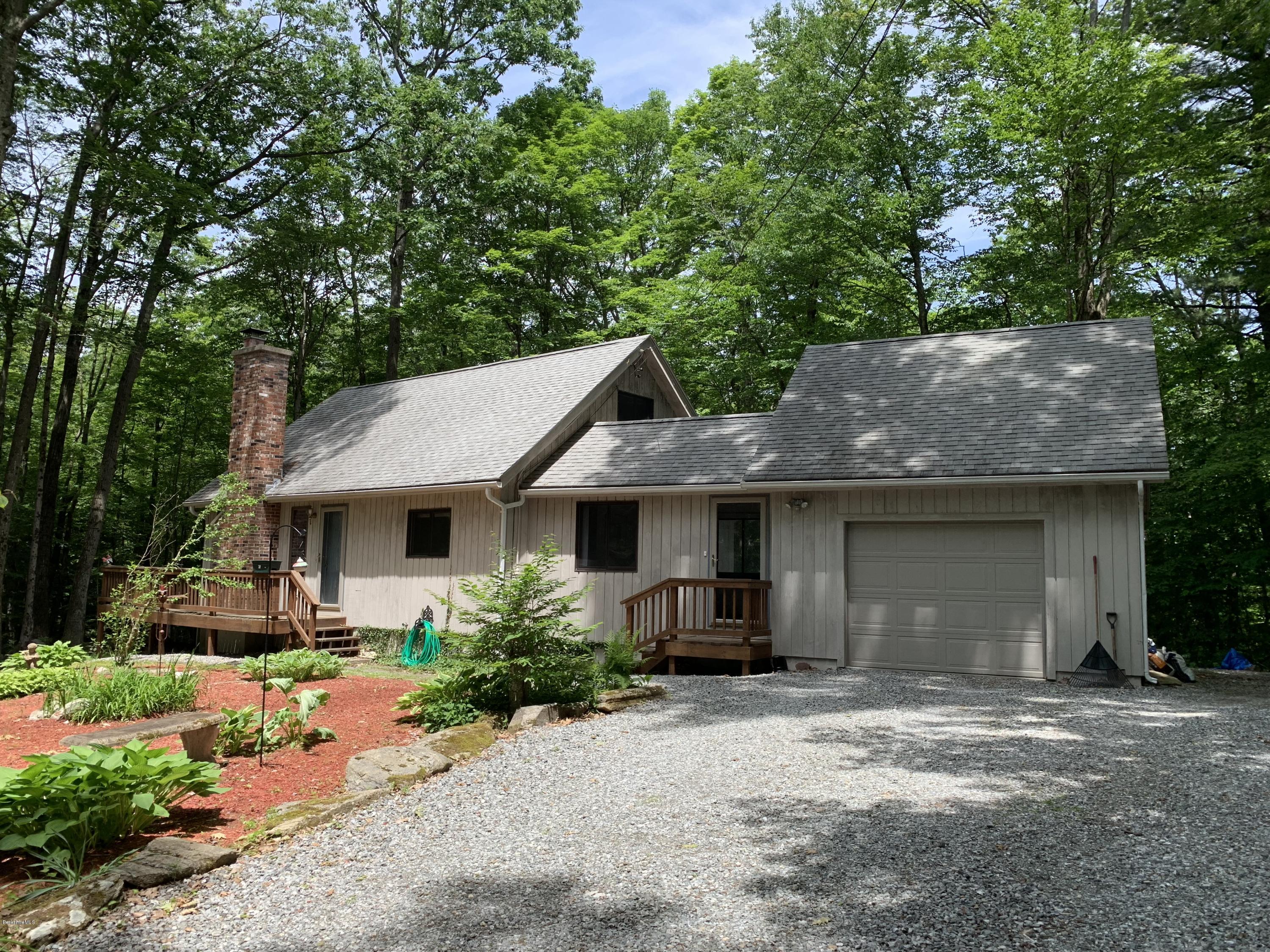 29 Pinnacle Road Otis, MA 01253 - Photo 2 of 37 a front view of a house with garden
