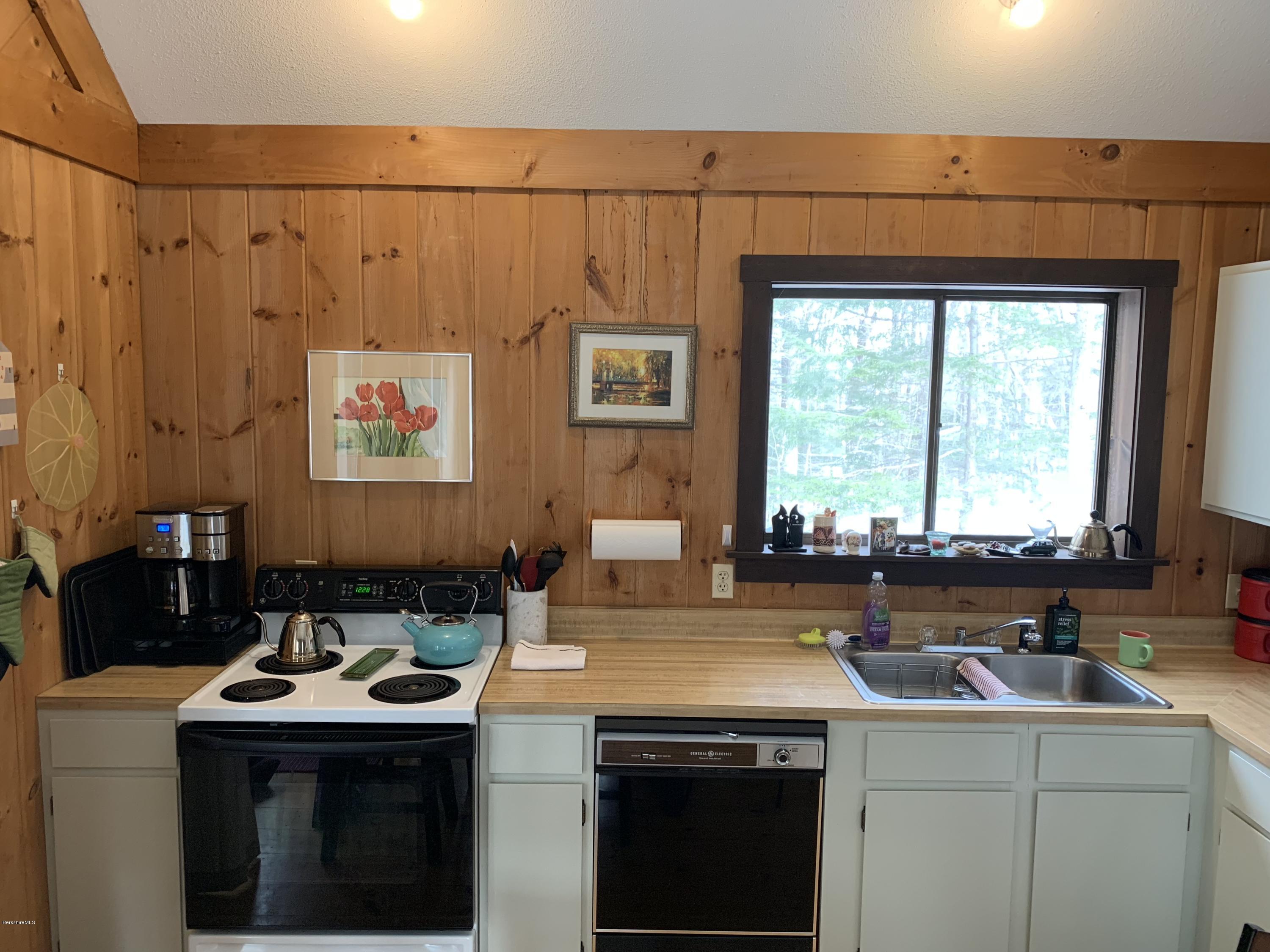 29 Pinnacle Road Otis, MA 01253 - Photo 12 of 37 a view of a kitchen with a sink a stove a microwave and cabinets