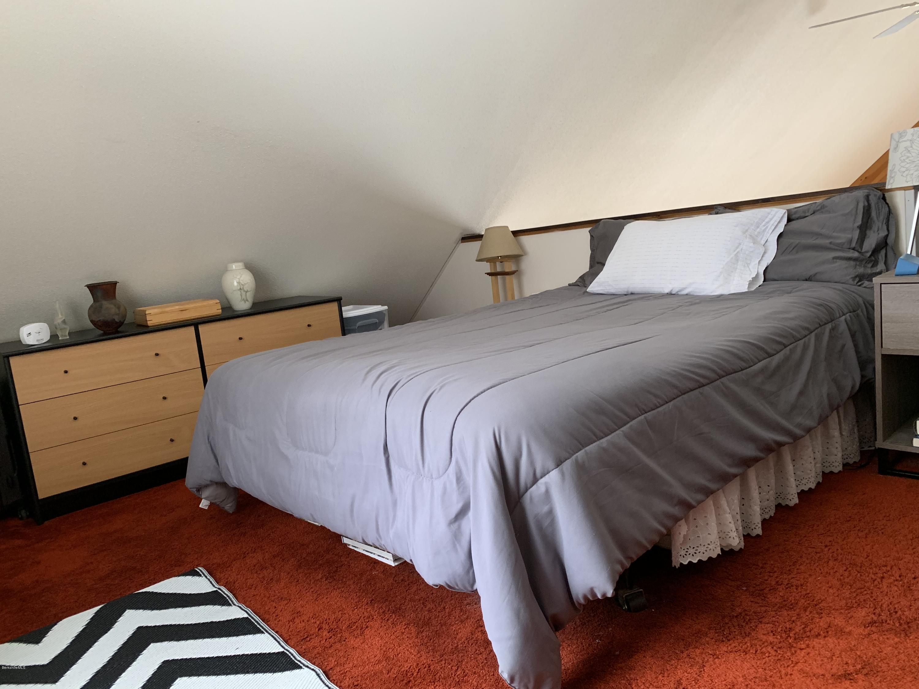 29 Pinnacle Road Otis, MA 01253 - Photo 18 of 37 a bedroom with a bed and wooden floor