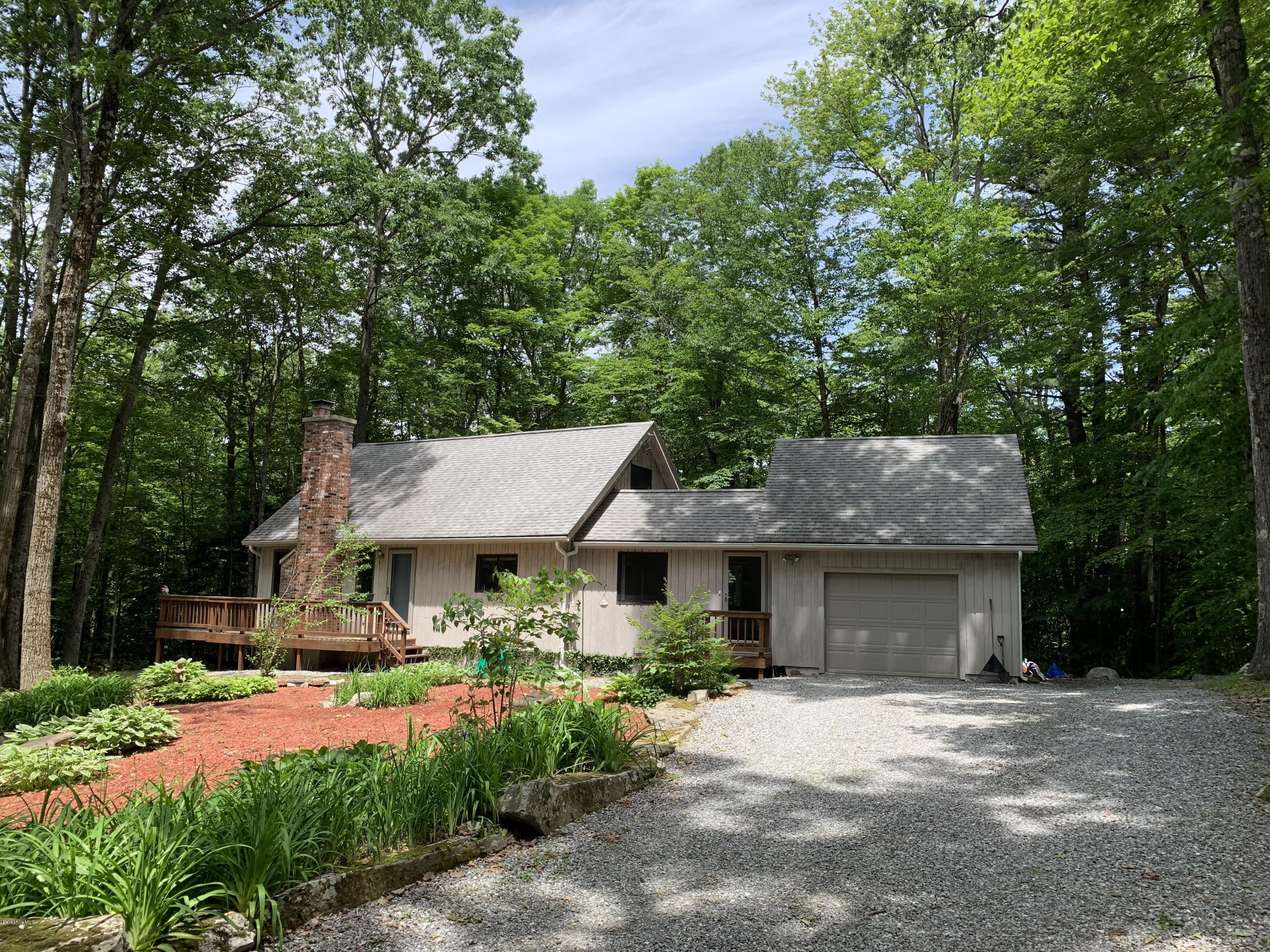 29 Pinnacle Road Otis, MA 01253 - Photo 36 of 37 a front view of a house with a garden and trees