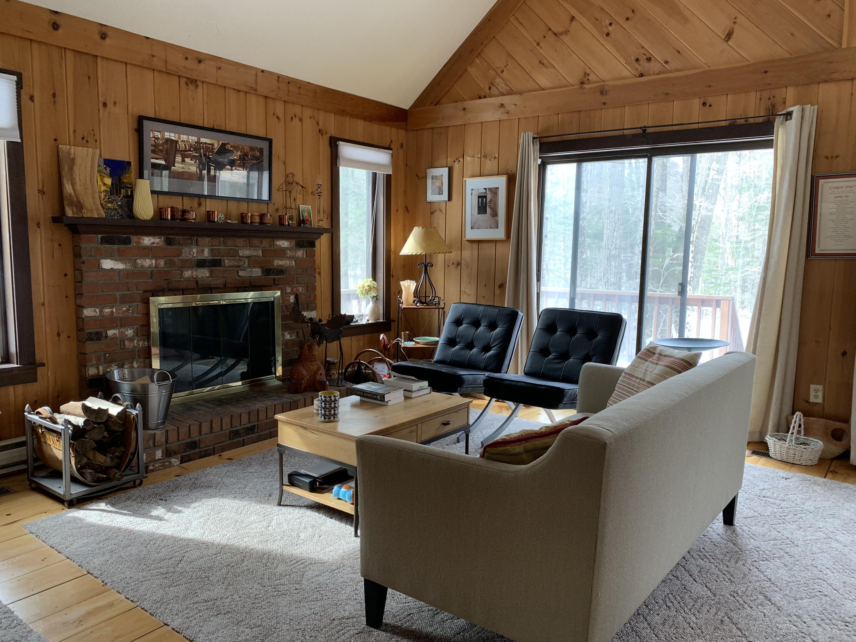 29 Pinnacle Road Otis, MA 01253 - Photo 5 of 37 a living room with furniture a large window and a fireplace