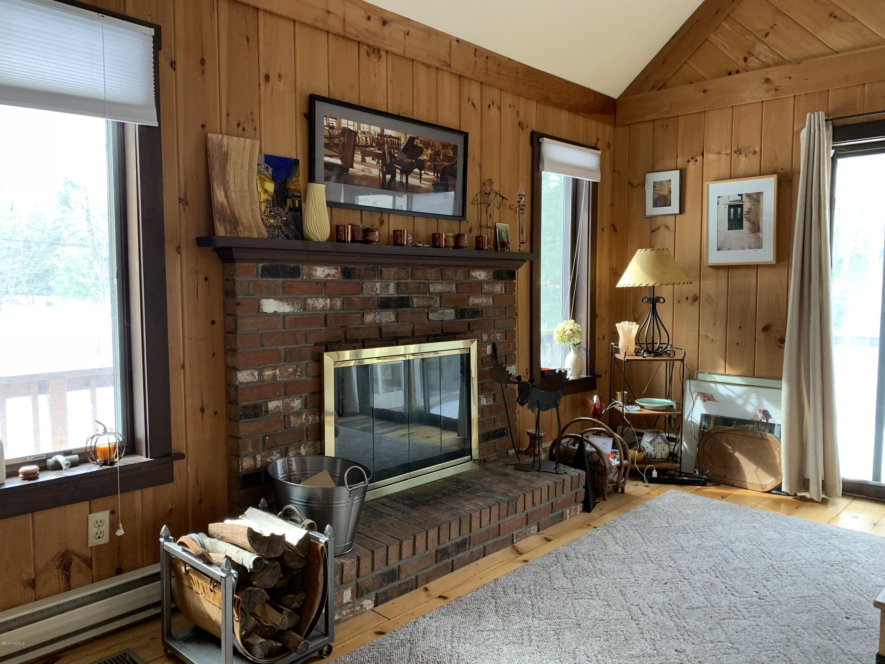 29 Pinnacle Road Otis, MA 01253 - Photo 6 of 37 a living room with furniture a flat screen tv and a fireplace
