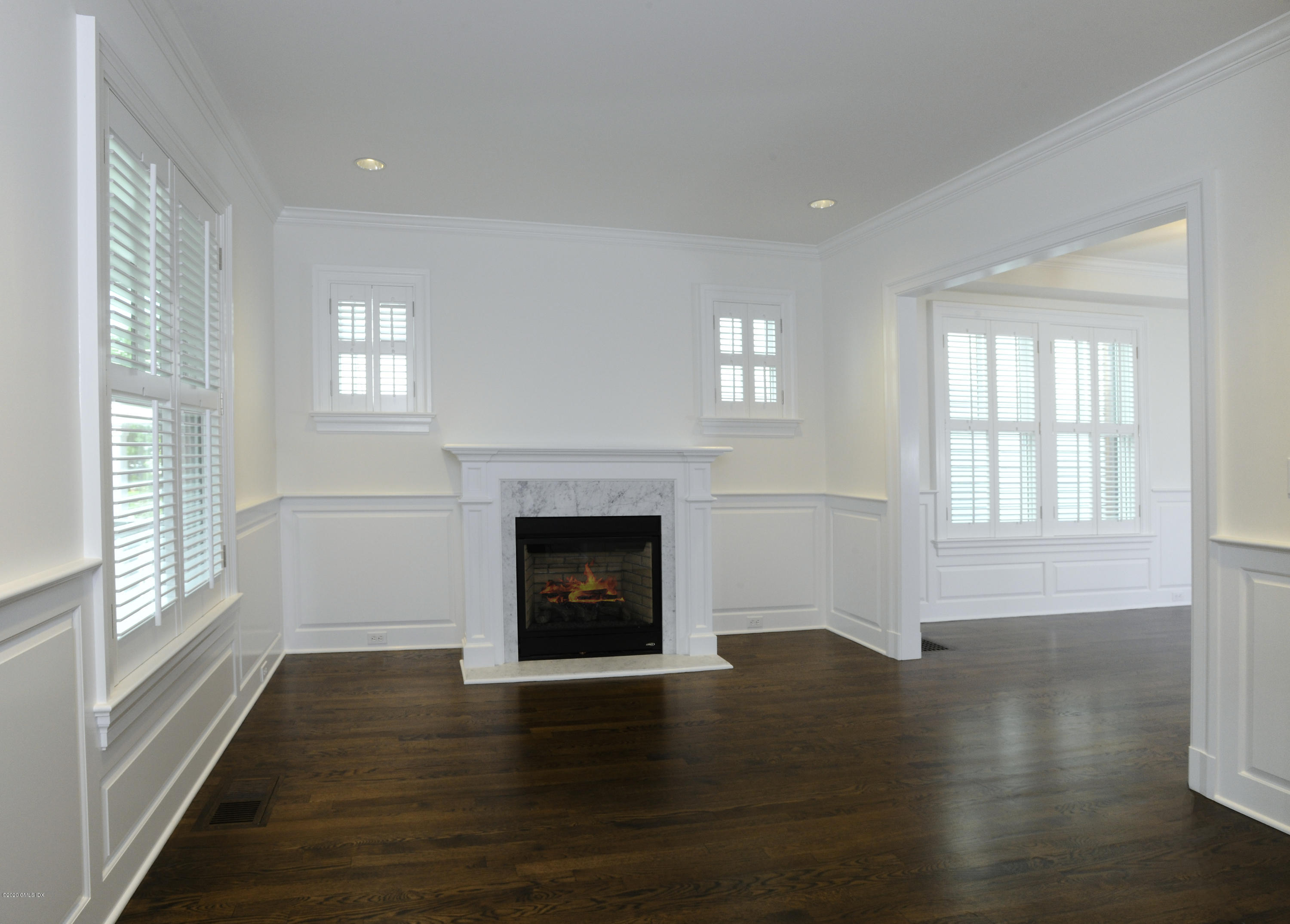13 Grigg Street Greenwich, CT 06830 - Photo 20 of 30 a view of an empty room with wooden floor fireplace and a window