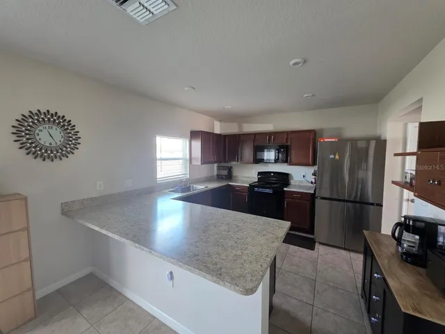 a kitchen with a refrigerator sink and stove