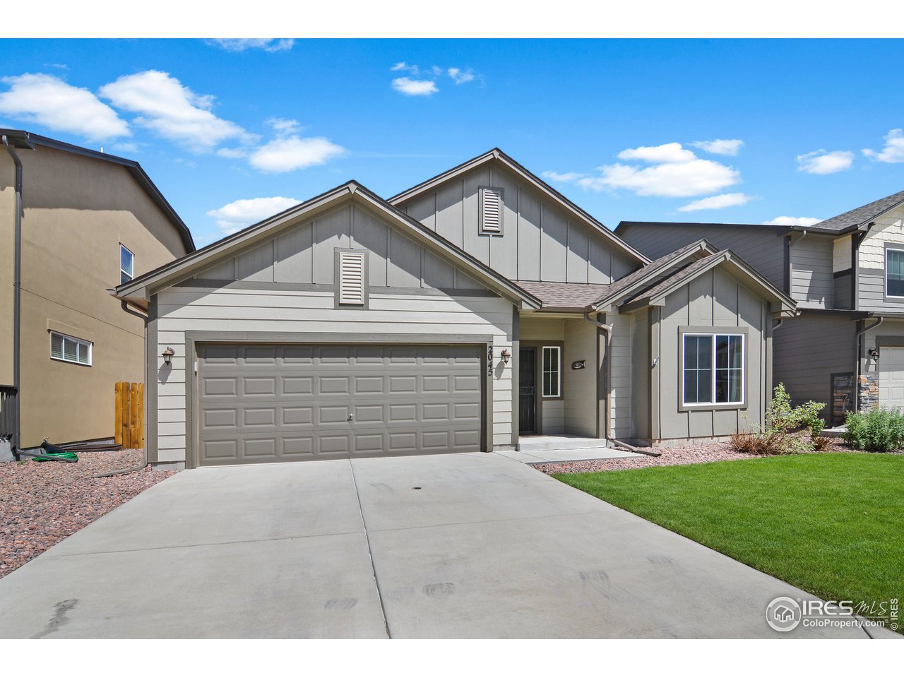 2045 Reed Grass Way Colorado Springs, CO 80915 - Photo 1 of 33 a front view of a house with a yard and garage