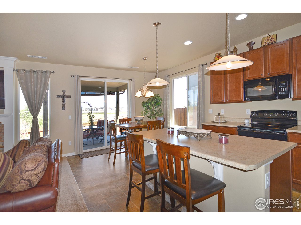 2045 Reed Grass Way Colorado Springs, CO 80915 - Photo 11 of 33 a kitchen with a dining table chairs and granite counter tops