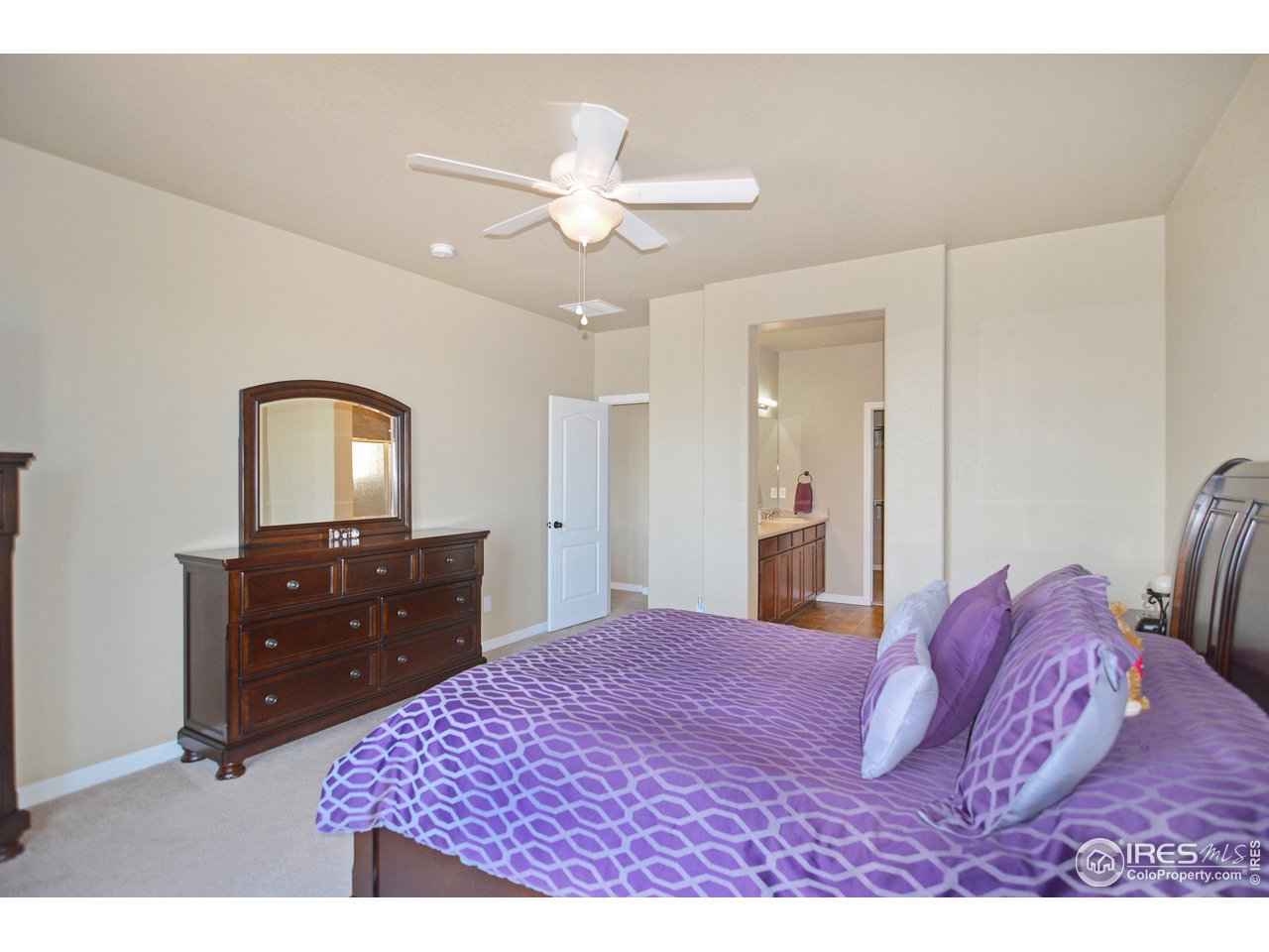 2045 Reed Grass Way Colorado Springs, CO 80915 - Photo 14 of 33 a bedroom with a bed and a dresser