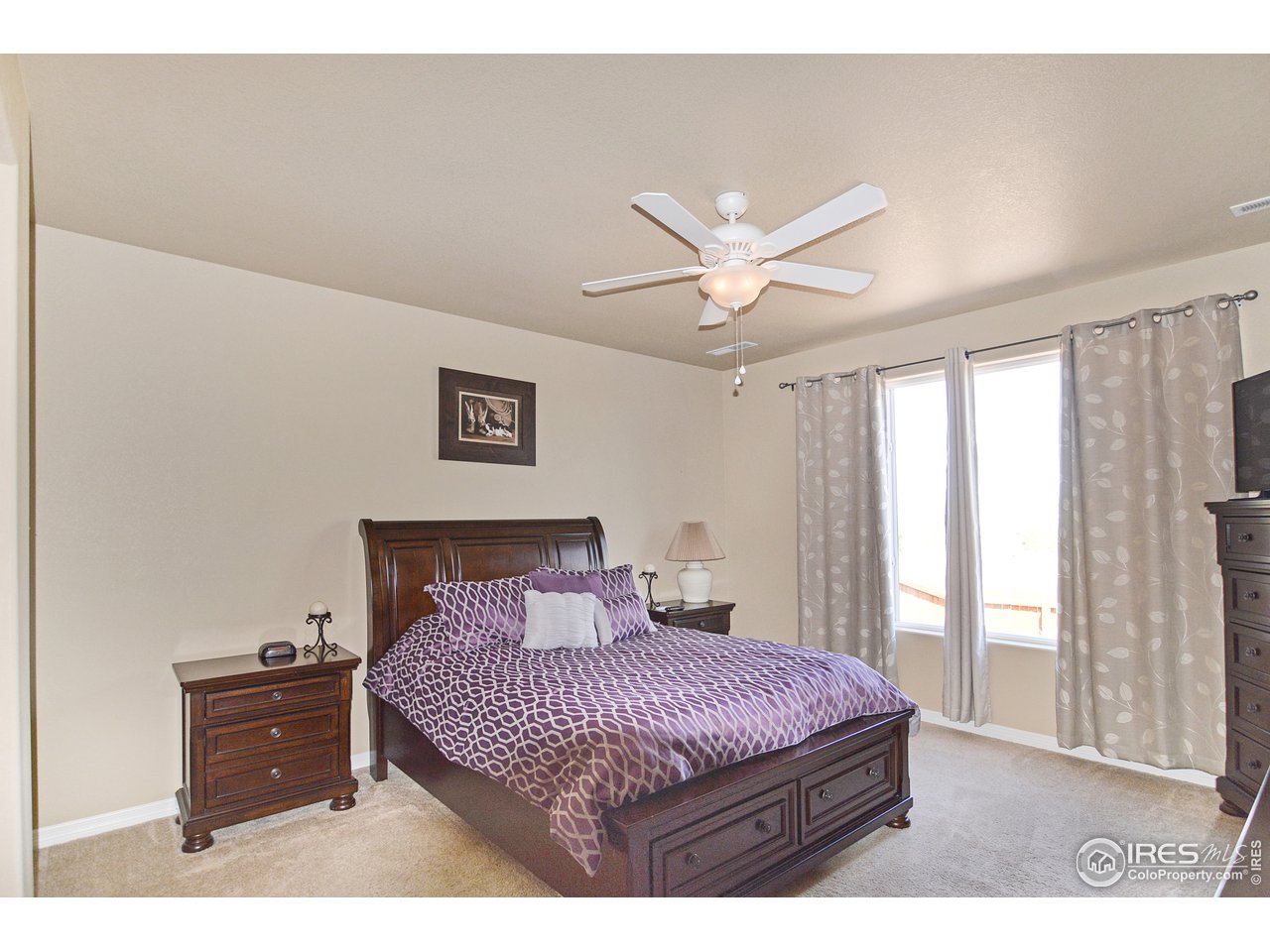 2045 Reed Grass Way Colorado Springs, CO 80915 - Photo 15 of 33 a bedroom with a large bed and a window